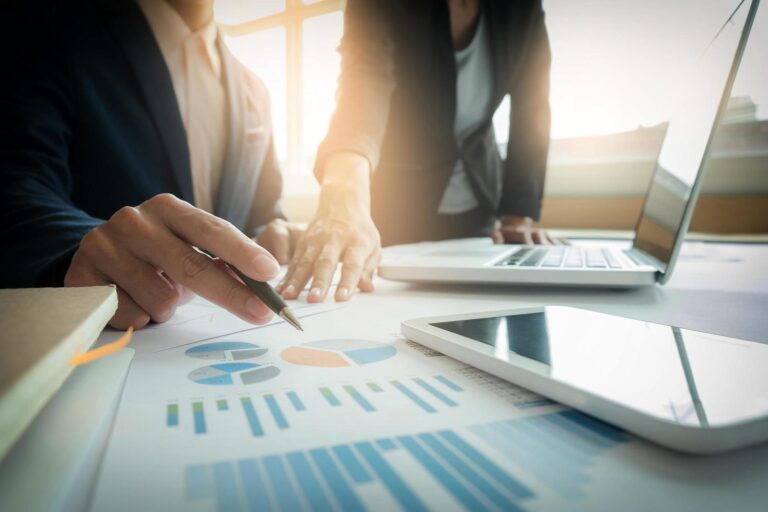 two colleagues discussing new financial plan free photo